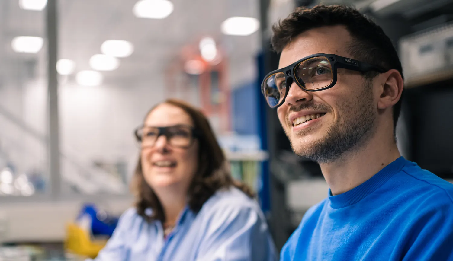 Two researchers wearing Tobii Pro Glasses 3 eye tracking glasses in a lab